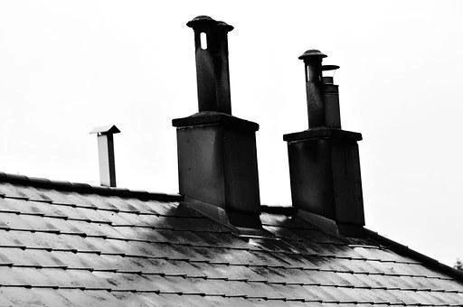 two black chimneys on a slate roof in Cardiff